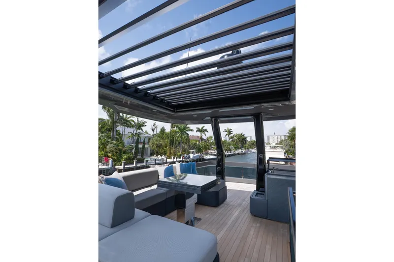 Slide: The Image of 2024 Explorer EX62 yacht with open deck, modern seating, and scenic waterfront view. - 37