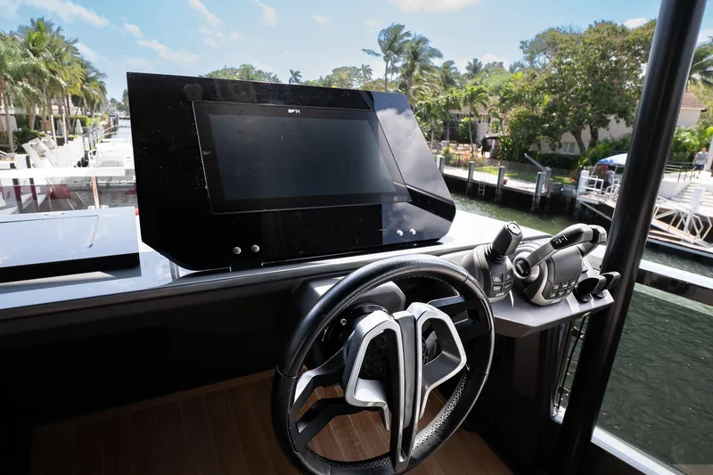 Slide: The Image of 2024 Explorer EX62 yacht helm with advanced navigation controls and waterfront view. - 39