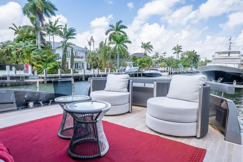 Slide: The Image of Luxurious 2024 Explorer EX62 yacht deck with plush seating and scenic waterfront view. - 4
