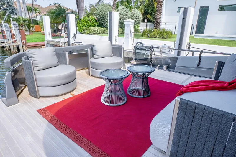 Slide: The Image of Luxurious 2024 Explorer EX62 yacht deck with modern seating and red carpet. - 5