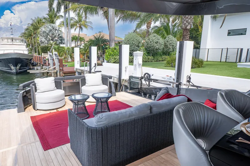 Slide: The Image of Luxurious 2024 Explorer EX62 yacht deck with elegant seating and scenic waterfront view. - 6