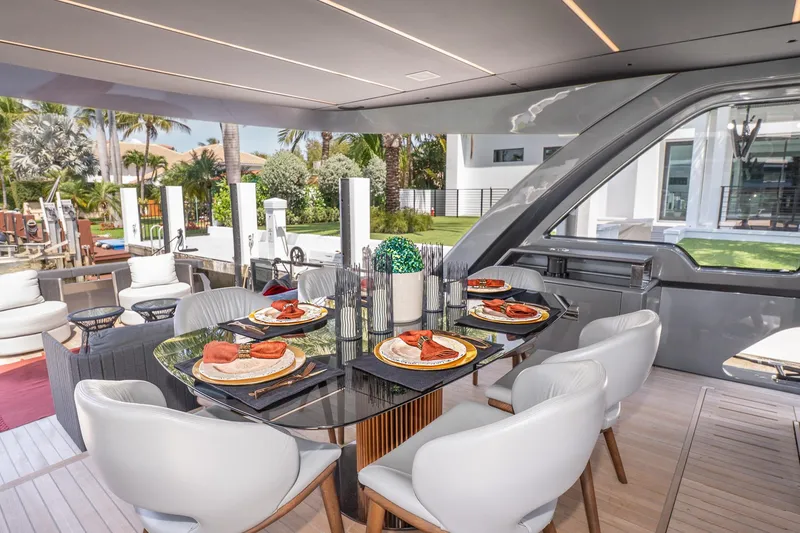 Slide: The Image of Luxurious 2024 Explorer EX62 yacht dining area with elegant table setting and modern decor. - 8