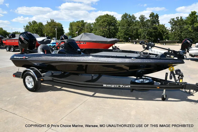 The Image of 2026 Ranger Z185 boat on trailer, displayed outdoors with trees in the background. - 0