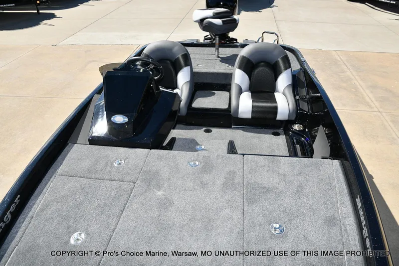 Slide: The Image of 2026 Ranger Z185 boat interior with gray carpet and dual seats. - 5