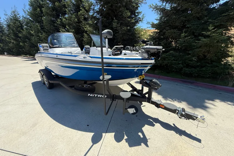 Slide: The Image of 2026 Nitro ZV19 Sport Pro boat on trailer, parked outdoors with trees in background. - 3