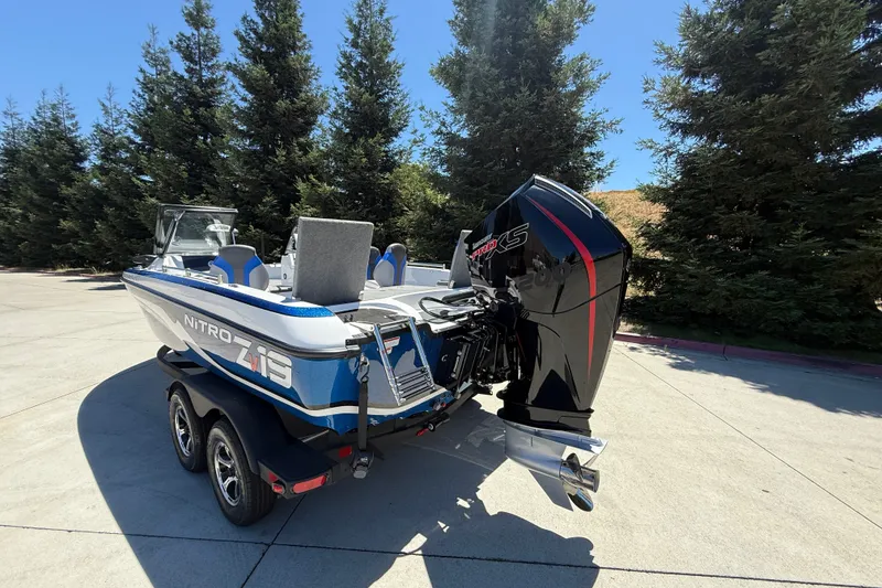 Slide: The Image of 2026 Nitro ZV19 Sport Pro boat with powerful outboard motor, parked outdoors. - 4