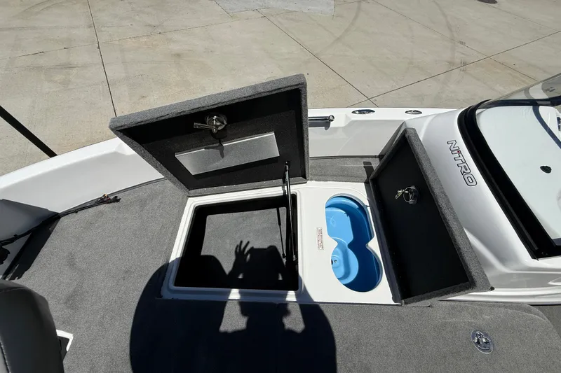 Slide: The Image of Open storage compartments on a 2026 Nitro ZV19 Sport Pro boat deck. - 25
