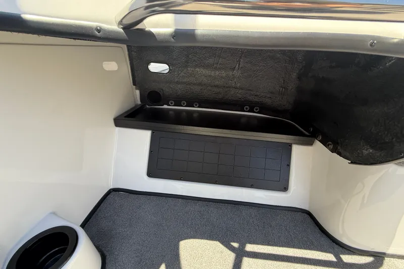 Slide: The Image of Interior view of 2026 Nitro ZV19 Sport Pro boat, featuring storage compartment and carpeted flooring. - 20
