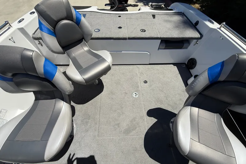Slide: The Image of Interior of 2026 Nitro ZV19 Sport Pro boat with gray and blue seating. - 28