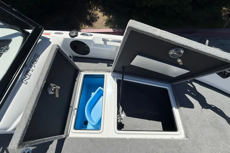 Slide: The Image of Open storage compartments on a 2026 Nitro ZV19 Sport Pro boat deck. - 24