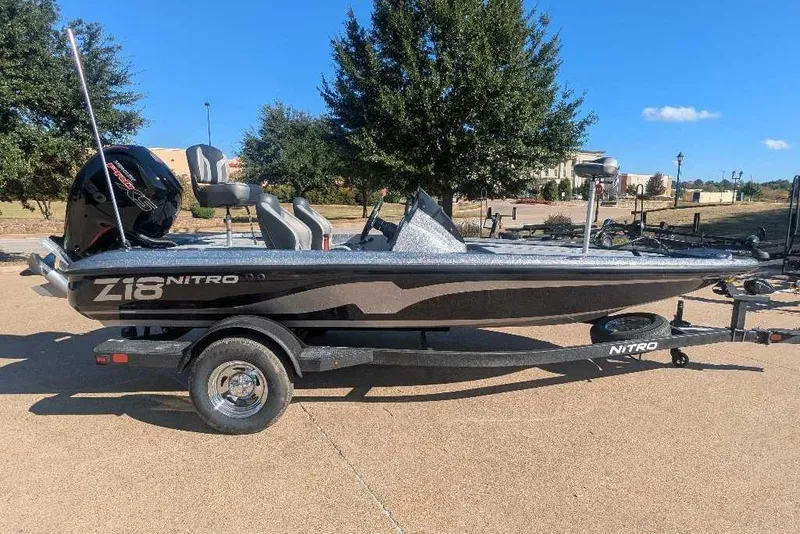 The Image of 2026 Nitro Z18 boat on trailer, parked outdoors under clear blue sky. - 1