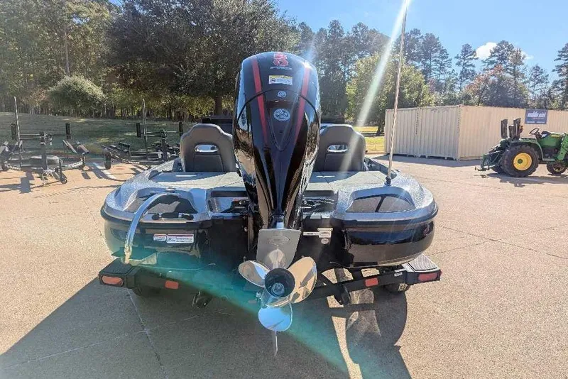 Slide: The Image of 2026 Nitro Z18 boat with powerful outboard motor, parked outdoors on a sunny day. - 4