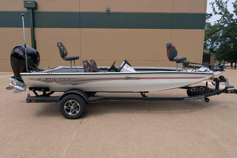 The Image of 2026 Ranger RT198P fishing boat on trailer, parked outdoors. - 2