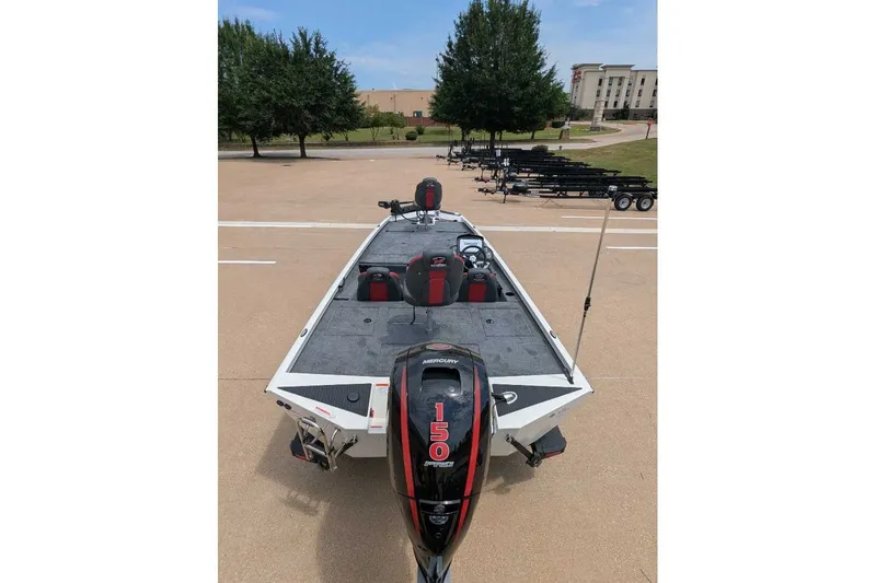 Slide: The Image of 2026 Ranger RT198P boat with Mercury 150 engine, parked outdoors. - 22