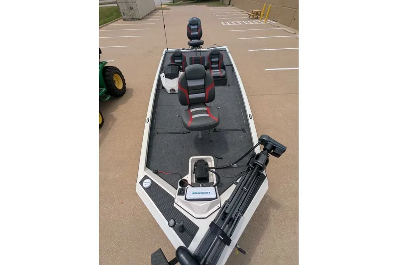 Slide: The Image of 2026 Ranger RT198P fishing boat with seating and trolling motor in a parking lot. - 25