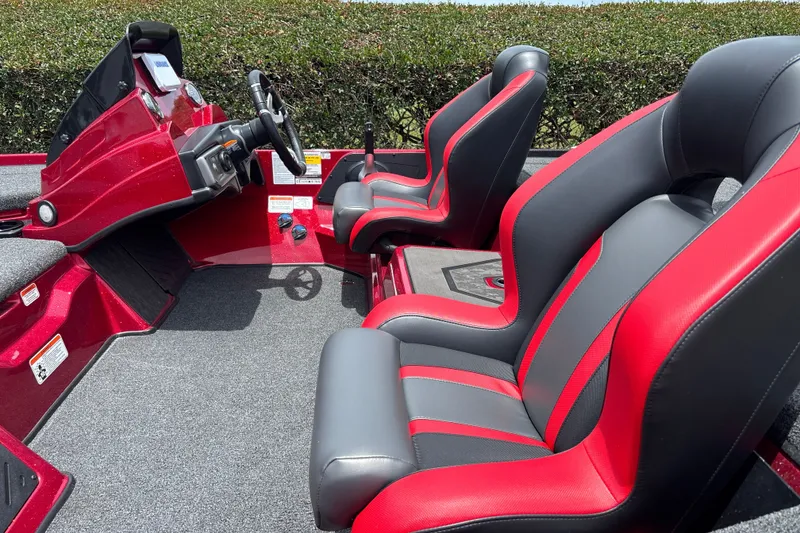 Slide: The Image of 2026 Nitro Z20 XL boat interior with red and gray seats, steering console. - 17