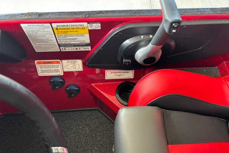 Slide: The Image of Interior of 2026 Nitro Z20 XL boat showing controls and red seating. - 18