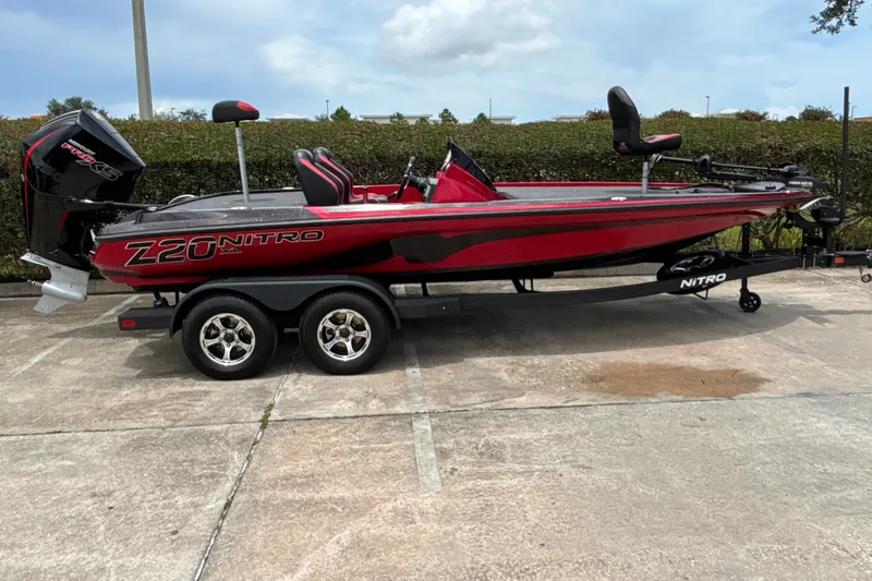 Slide: The Image of 2026 Nitro Z20 XL boat with dual axle trailer, parked outdoors. - 4