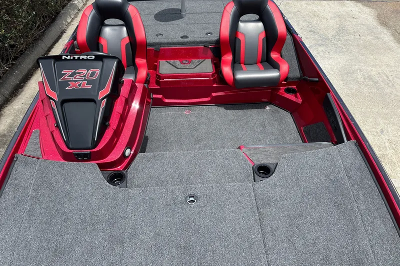 Slide: The Image of 2026 Nitro Z20 XL boat interior with red and black seats, carpeted deck. - 19