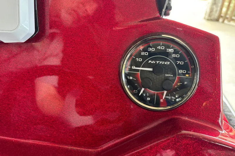 Slide: The Image of Close-up of a 2026 Nitro Z20 XL speedometer on a red metallic dashboard. - 14