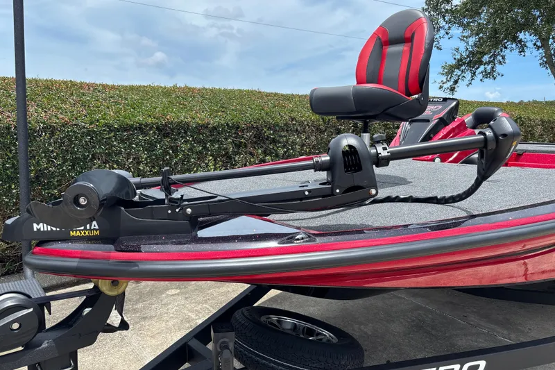 Slide: The Image of 2026 Nitro Z20 XL boat with Minn Kota Maxxum trolling motor, red and black seating. - 3