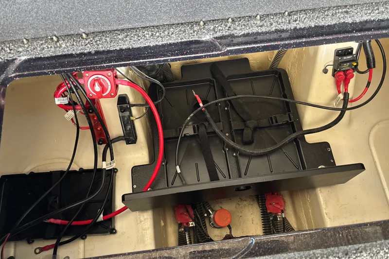Slide: The Image of Battery compartment of a 2026 Nitro Z20 XL boat with wiring and switches. - 31