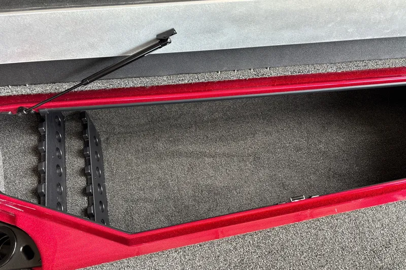 Slide: The Image of Open storage compartment in 2026 Nitro Z20 XL boat, featuring carpeted interior and hydraulic lift. - 25