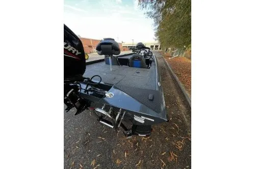 Slide: The Image of 2026 Ranger RT178C fishing boat with motor, parked outdoors on a sunny day. - 4
