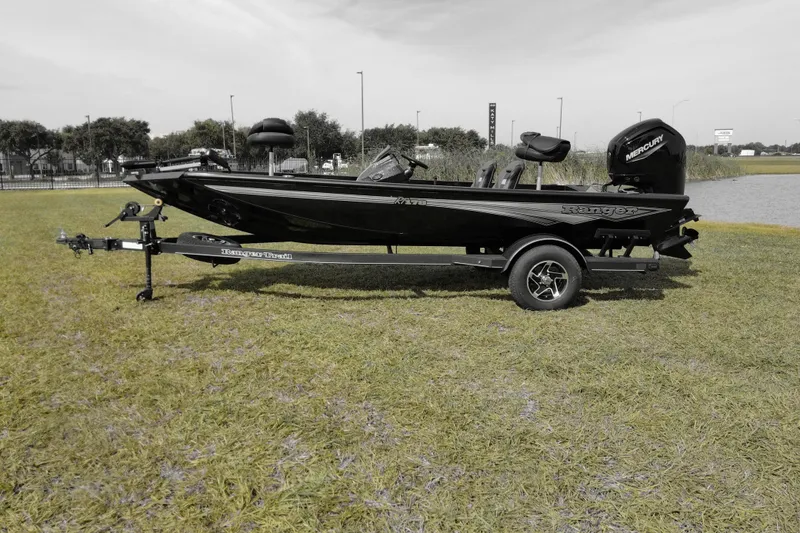 Slide: The Image of 2026 Ranger RT178 boat on trailer, parked on grass near a lake. - 1
