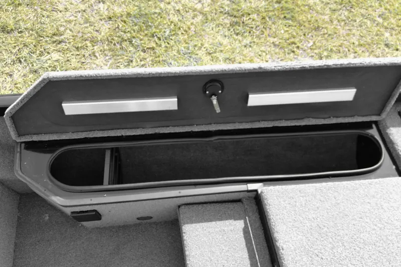 Slide: The Image of Open storage compartment in 2026 Ranger RT178 boat, featuring secure lock and carpeted interior. - 10