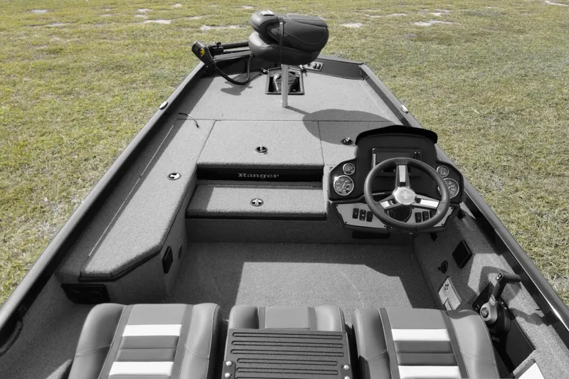 Slide: The Image of 2026 Ranger RT178 boat interior with steering wheel and seating on grassy area. - 73