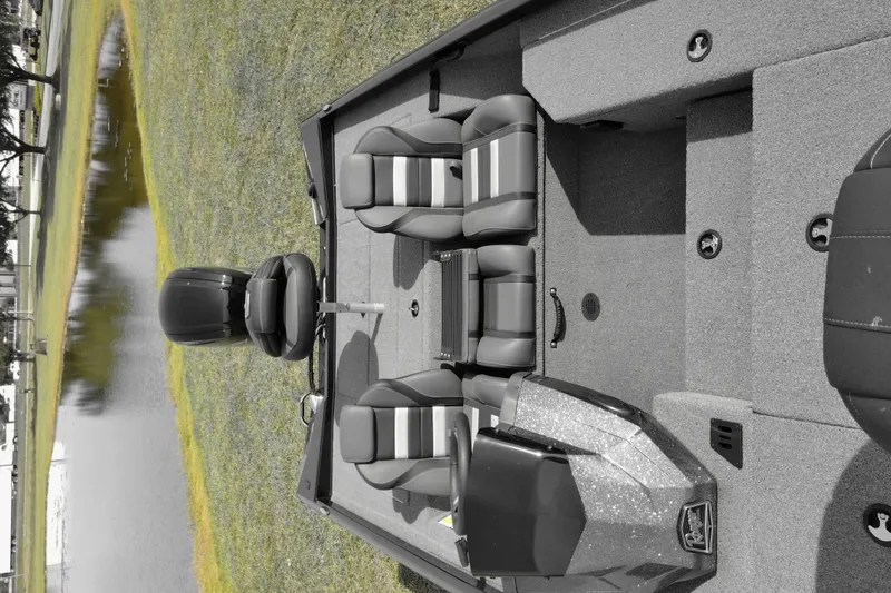 Slide: The Image of 2026 Ranger RT178 boat interior with seating, near a serene pond. - 74