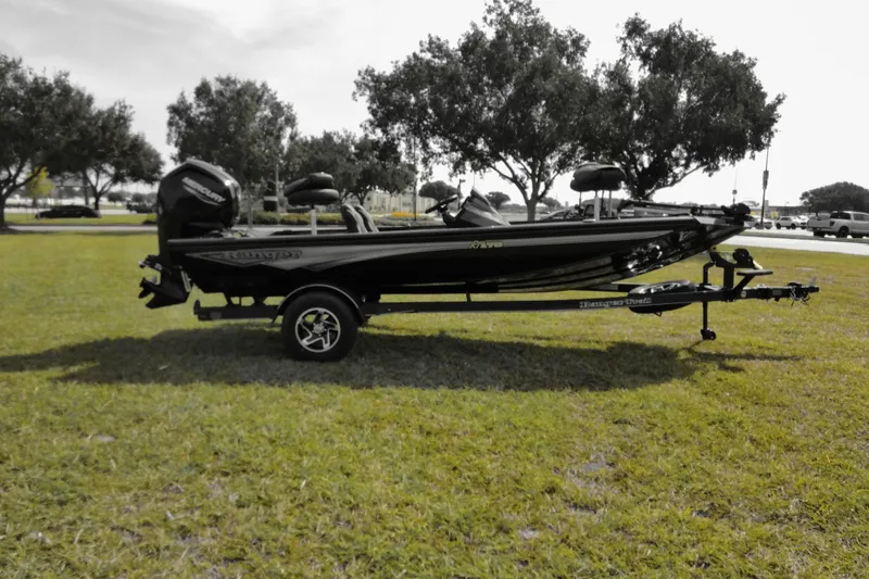 Slide: The Image of 2026 Ranger RT178 boat on trailer, parked on grass with trees in background. - 5