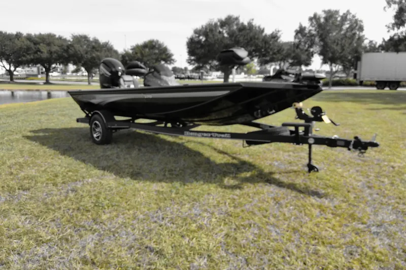 Slide: The Image of 2026 Ranger RT178 boat on trailer, parked on grass with trees in background. - 72
