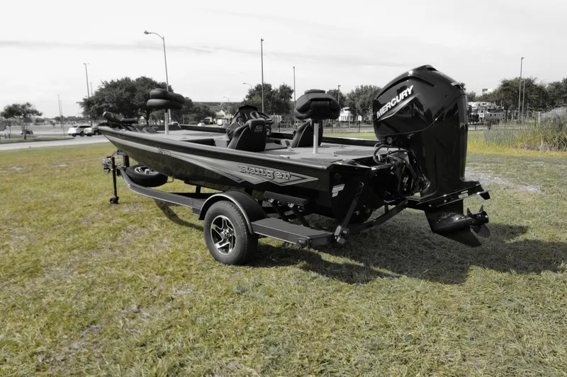Slide: The Image of 2026 Ranger RT178 boat with Mercury engine on grassy area, showcasing sleek design. - 2