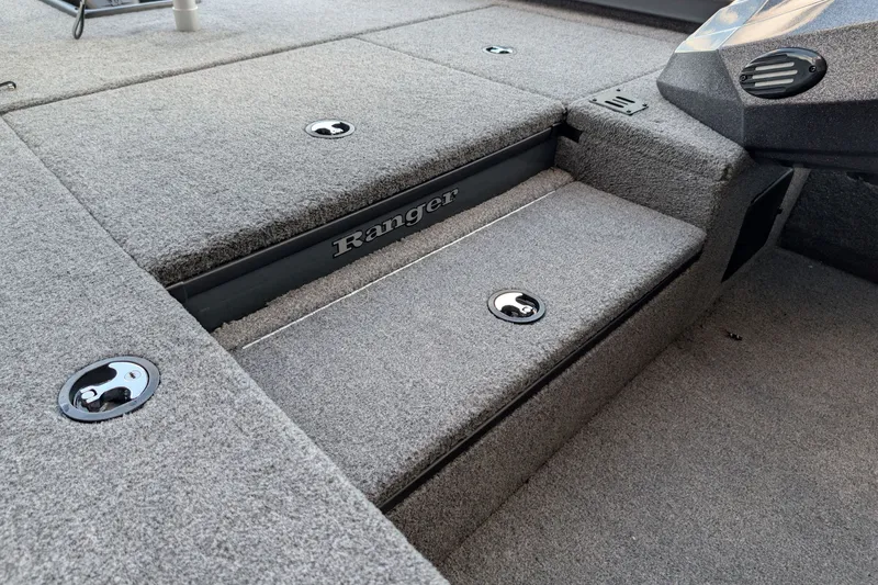 Slide: The Image of 2026 Ranger RT178 boat interior with carpeted storage compartments and sleek design. - 11