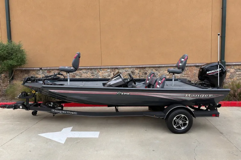 The Image of 2026 Ranger RT178 fishing boat with Mercury engine on trailer, parked outdoors. - 0