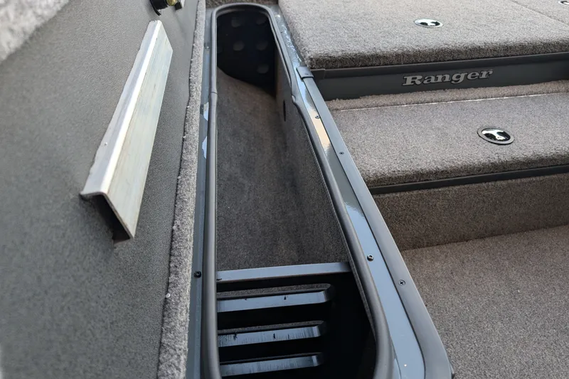Slide: The Image of Interior view of 2026 Ranger RT178 boat, showcasing storage compartment and carpeted flooring. - 9