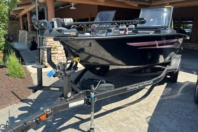 Slide: The Image of 2026 Ranger VX1888 WT boat on trailer, parked outdoors, featuring Minn Kota trolling motor. - 7