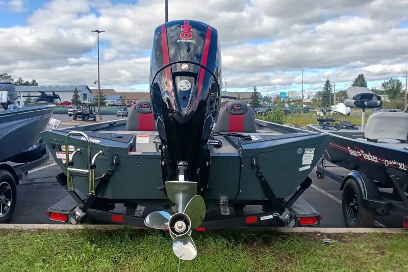 Slide: The Image of 2026 Ranger RT198P boat with powerful outboard motor in a parking lot. - 1