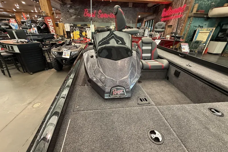 Slide: The Image of 2026 Ranger RT188C boat displayed in a showroom with modern seating and sleek design. - 5