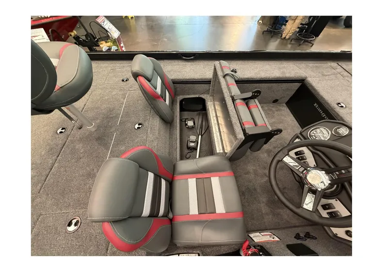 Slide: The Image of 2026 Ranger RT188C boat interior with gray and red seating, steering wheel, and storage compartments. - 2