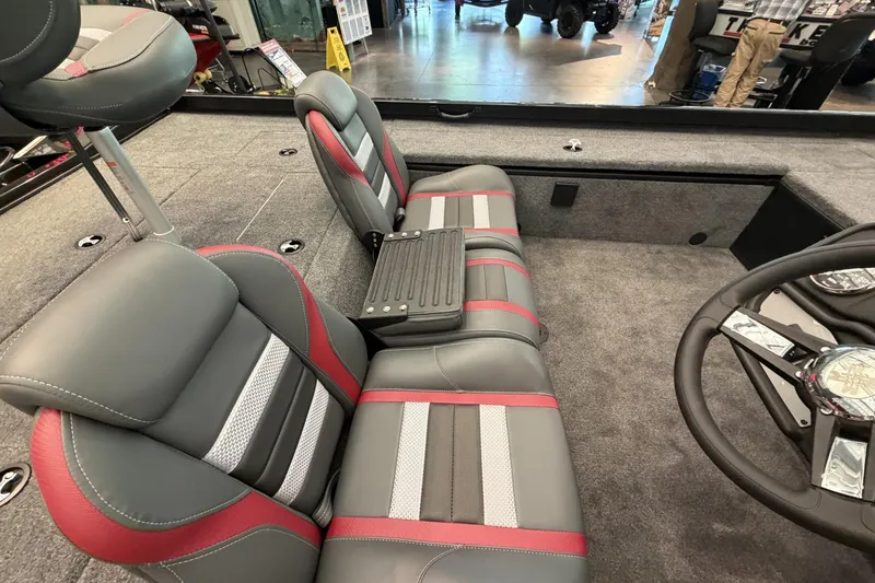 Slide: The Image of 2026 Ranger RT188C boat interior with gray and red seating, steering wheel, and carpeted flooring. - 7