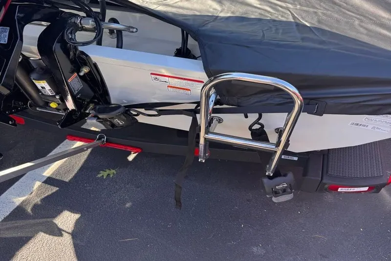 Slide: The Image of 2026 Ranger RT188 boat with cover, ladder, and motor, parked on asphalt. - 104