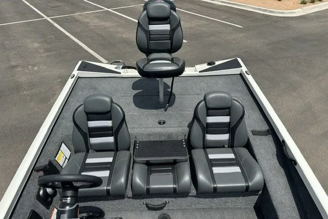 Slide: The Image of 2026 Ranger RT188 boat interior with three gray seats and steering wheel. - 19