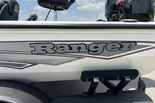 Slide: The Image of Close-up of the Ranger RT188 boat with gray lettering and a motor in the background. - 2