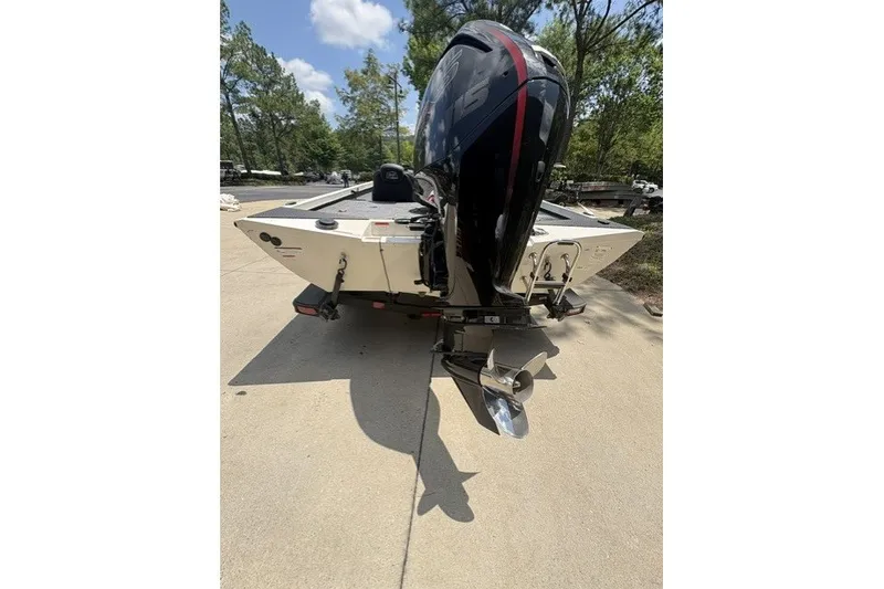 Slide: The Image of 2026 Ranger RT188 boat with powerful outboard motor, parked on a sunny driveway. - 4