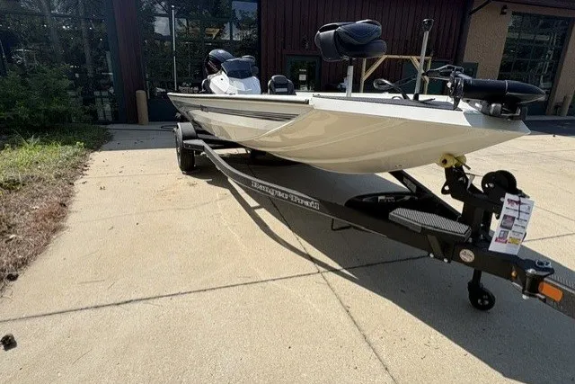 Slide: The Image of 2026 Ranger RT188 boat on trailer, parked outdoors, showcasing sleek design and modern features. - 2