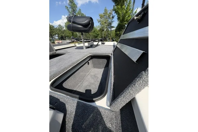 Slide: The Image of 2026 Ranger RT188 boat interior with open storage compartment and seating. - 7