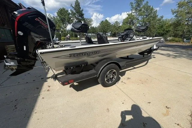 Slide: The Image of 2026 Ranger RT188 boat on trailer, parked outdoors, with trees in background. - 3